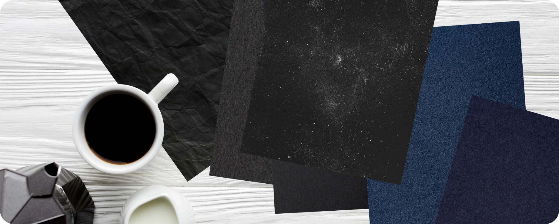 Seven papers and four envelopes in rich noir tones.
